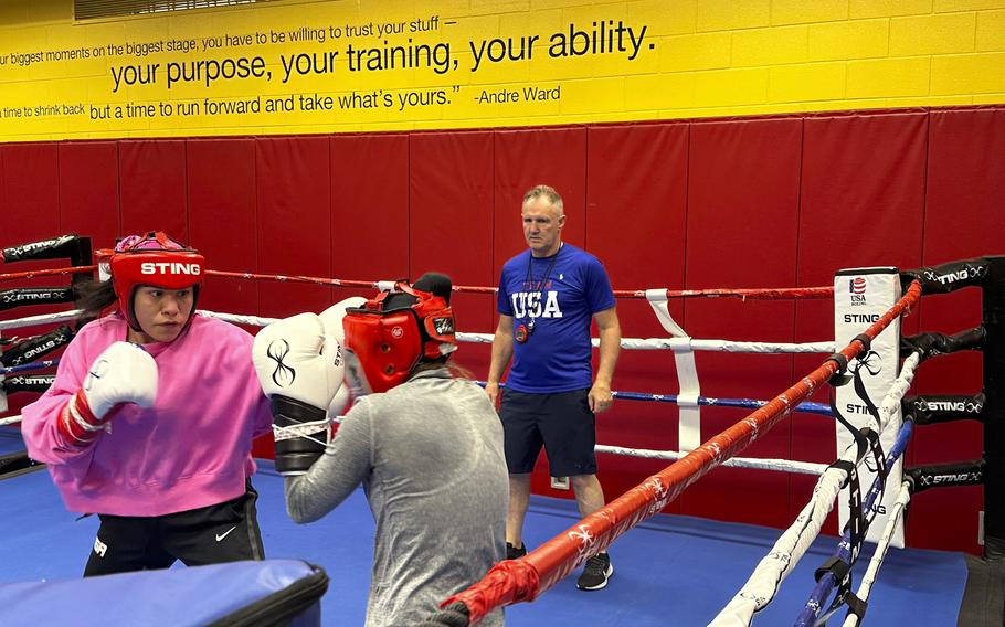 U.S. Olympic boxer Jajaira Gonzalez, left, spars with teammate Jennifer Lozano while head coach Billy Walsh looks on at the U.S. Olympic Training Center in Colorado Springs, Colo., June 14, 2024. 