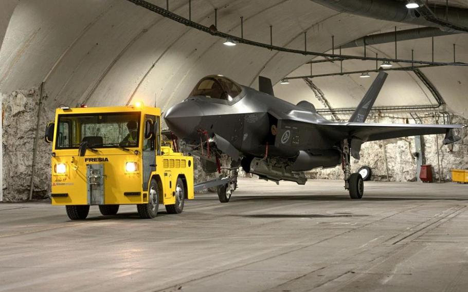 A tractor moves a Norwegian air force F-35 through a mountain hangar at Bardufoss Air Station in Norway in this undated photo. 
