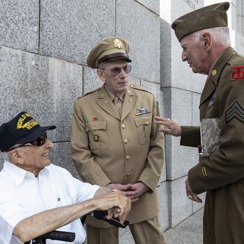 World War II Army veteran Col. Frank Cohn , left, talks with Patrick McCourt, center, and Sidney Wade before the 20th anniversary celebration of the National World War II Memorial in Washington, May 25, 2024.