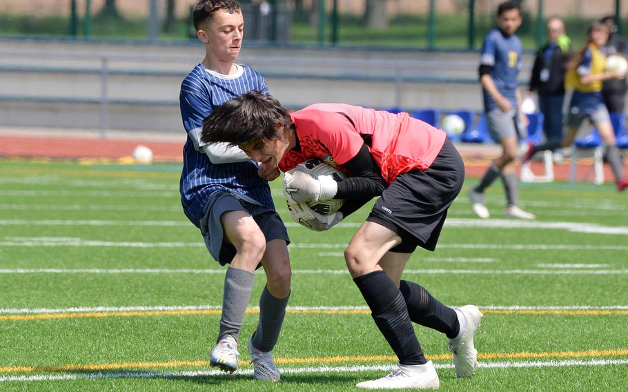 Sigonella keeper Ryan Griffith beats Ansbach’s Damien Abitua to the ball in the Division III boys final at the DODEA-Europe soccer championships in Ramstein, Germany, May 18, 2023. Sigonella won 4-1.