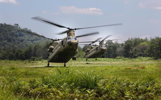 U.S. soldiers land CH-47 Chinooks during the Orient Shield exercise at Aibano Training Area, Japan, July 22, 2024. 