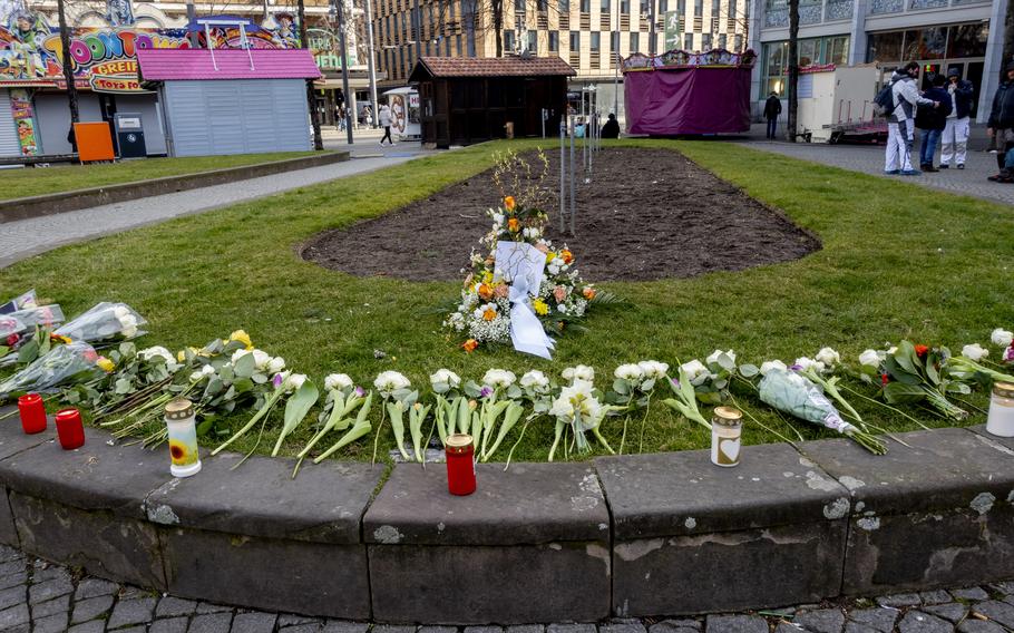 Flowers and candles create a memorial in downtown Mannheim.