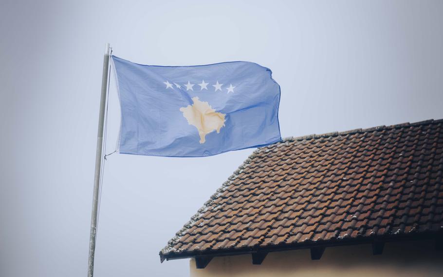 Kosovo flag flies over building as U.S. Army National Guard soldiers train in Germany for Kosovo peacekeeping mission.