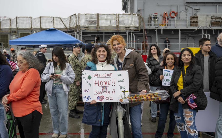 Friends and family wait for the USS O’Kane to pull into its homeport