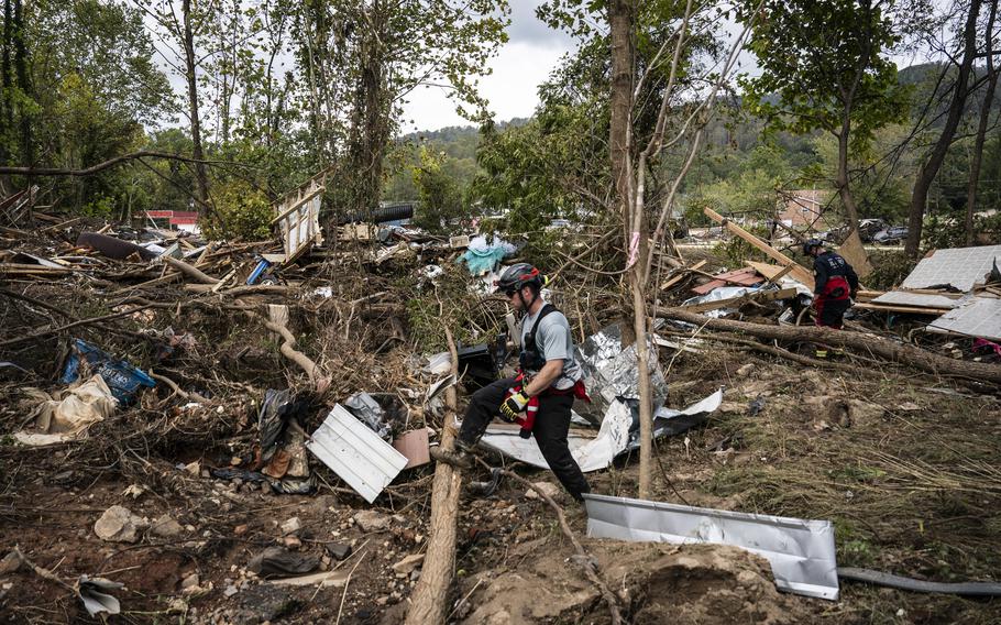 Members of the Illinois Water Rescue One team search through debris for survivors of Hurricane Helene in Swannanoa, N.C., on Tuesday.