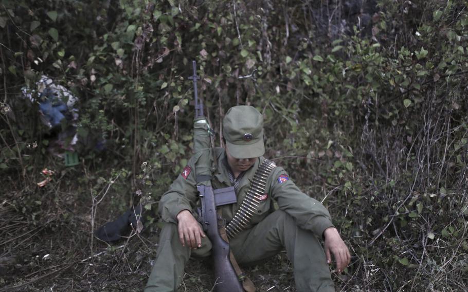 a rebel soldier with the Myanmar National Democratic Alliance Army (MNDAA) rests in a camp in the Kokang region of Myanmar in 2015.