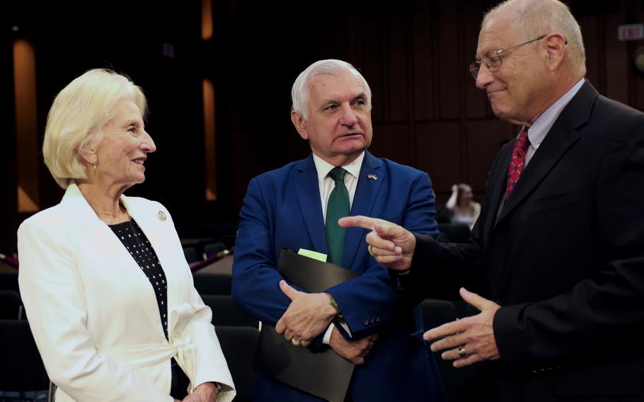 Jane Harman, left, chairwoman of the Commission on the National Defense Strategy, and Eric Edelman, vice chairman of the commission, right, talk with Sen. Jack Reed, D-R.I., chairman of the Senate Armed Services Committee, before a hearing Tuesday, July 30, 2024, on Capitol Hill.