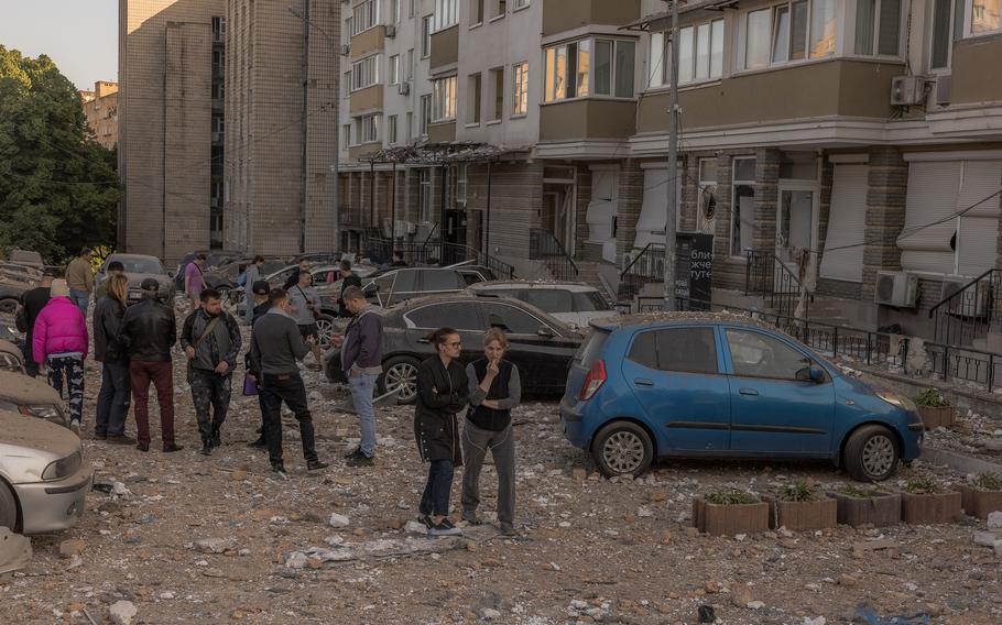 Residents gather at the site where an apartment building was hit during Russian drone attacks on May 30, 2023, in Kyiv, Ukraine.