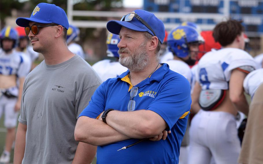 Michael Woodworth, middle, is in his thrid season as Yokota's football head coach.