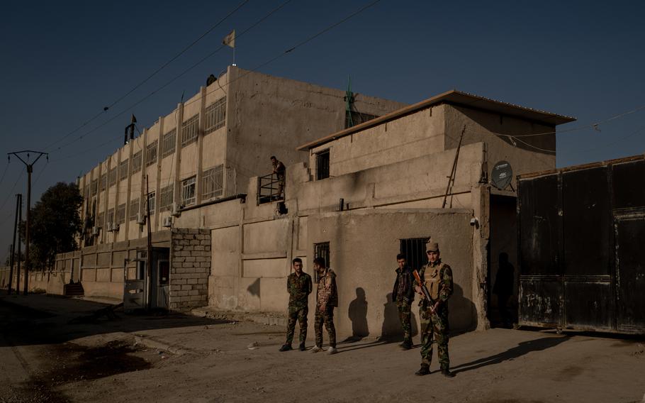 Fighters of the Syrian Democratic Forces guard the exterior of the Ghwaryan prison complex in Hasakah, Syria, on Feb. 2. 