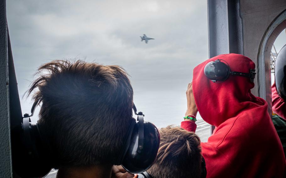 Sailors and their guests watch as an F-35C Lighting II, assigned to the “War Hawks” of Strike Fighter Squadron (VFA) 97, takes off from the flight deck aboard Nimitz-class aircraft carrier USS Carl Vinson (CVN 70) during an airpower demonstration while underway for a Family and Friends Day Cruise on Saturday, Aug. 17, 2024.