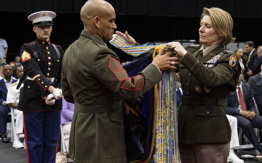 Outgoing SOUTHCOM commander Gen. Laura J. Richardson hands over the Joint Meritorious Unit Award streamer during a ceremony in Doral, Fla., Nov. 7, 2024.