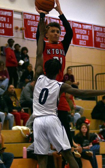 Caleb Ringer shoots over Gideon Toure.