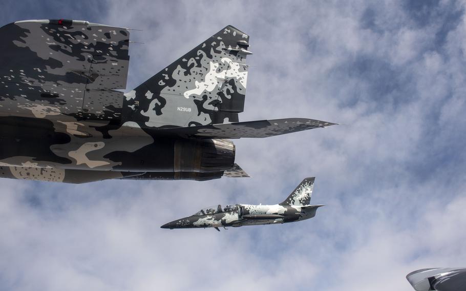 Jared Isaacman flies a MiG fighter in formation. Isaacman owns a fleet of fighter jets and is an elite pilot. 