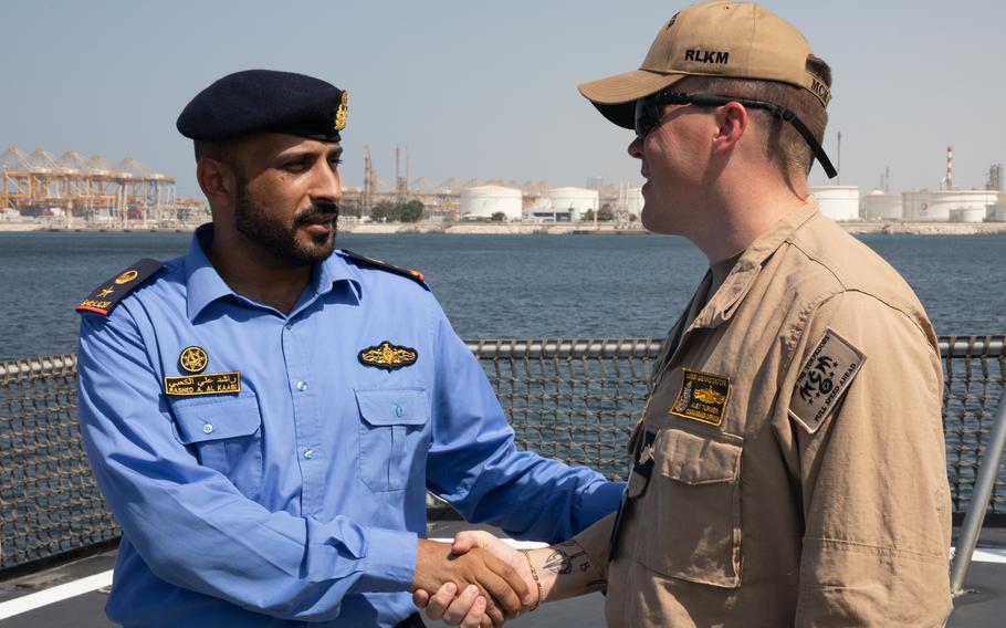 Navy Lt. Cmdr. Alex Turner shakes hands with a UAE officer.