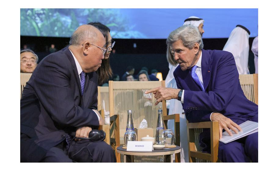  U.S. special climate envoy John Kerry speaks with China’s special representative on climate change, Xie Zhenhua at the COP28 summit.