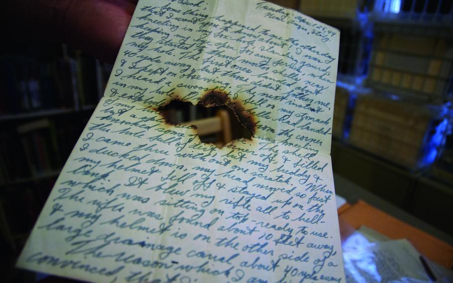 Andrew Carroll, founder of the Legacy Project, shows a letter written by a U.S. soldier in Anzio, Italy, during World War II. The letter was stored in the soldier’s pack and bears a bullet hole from when he was shot. The soldier survived.