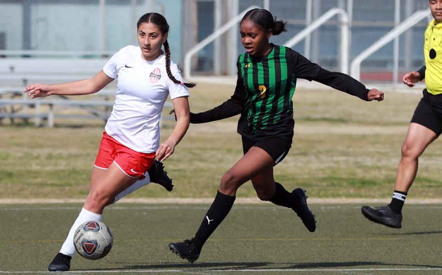 Kinnick's Rachael Vite and Eagles teammate Jada Stallworth chase the ball during Saturday's DODEA-Japan girls soccer match. The Red Devils won 10-0.