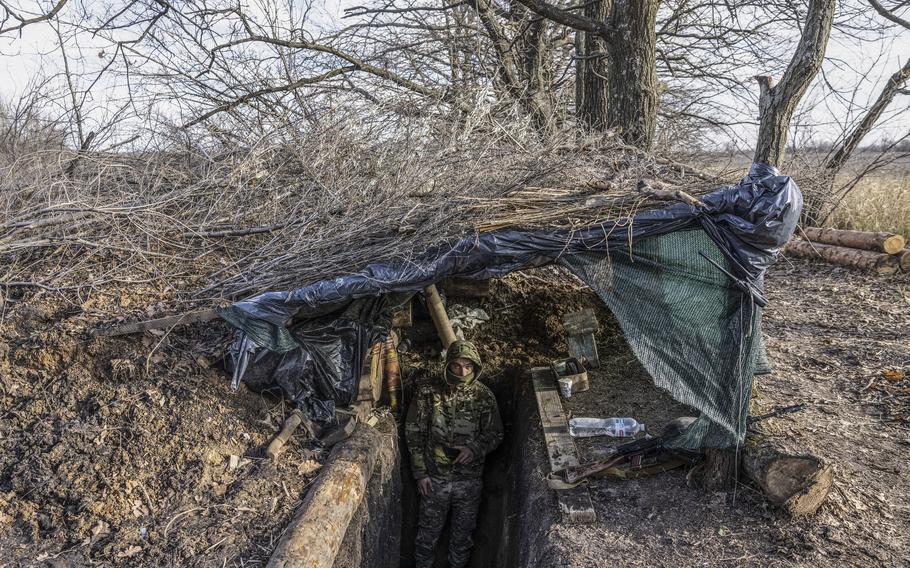 A Ukraine soldier stands at the entrance of a bunker at a military position in the Zaporizhzhia region in November. 