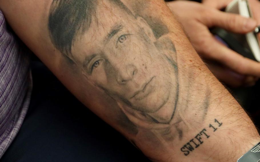 Brett Strickland displays a tattoo of his son, Lance Cpl. Evan Strickland, before a hearing on the Department of Defense’s V-22 Osprey program, June 12, 2024, on Capitol Hill in Washington. Lance Cpl. Strickland was among those killed on June 8, 2022, in the Southern California crash of a Marine Osprey, call sign Swift 11.