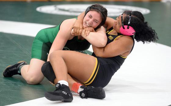 Kadena's Jasmine Kenney seizes control of Kubasaki's Isabella Sangiorgi at 180 pounds.