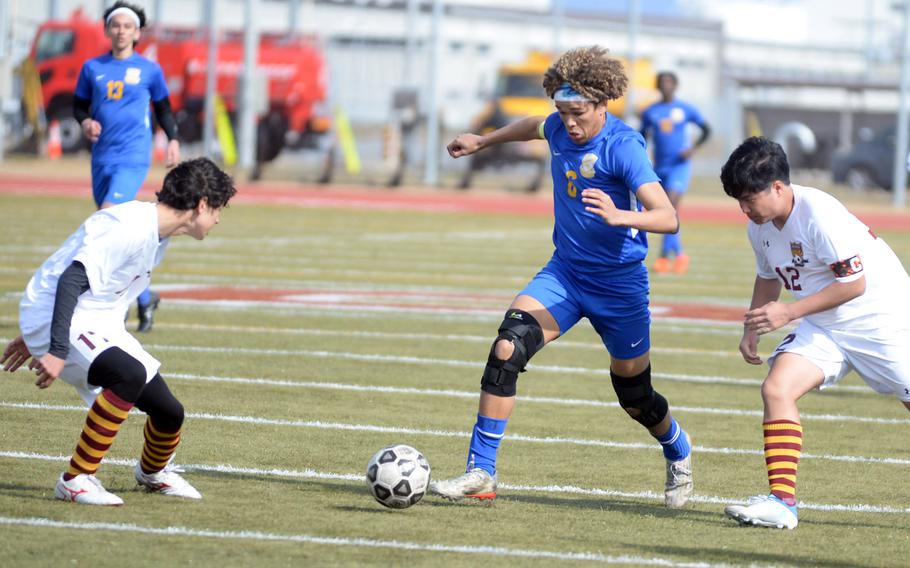 Yokota's Braedan Raybon dribbles between Matthew C. Perry's Cooper Allen and Zach Cruz during Friday's Perry Cup boys soccer match. The Panthers won 2-1.