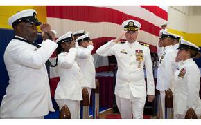 The incoming commander of Naval Support Activity Souda Bay, Capt. Stephen Steacy, salutes at the Aug. 1, 2024, change-of-command ceremony at the base on the Greek island of Crete.