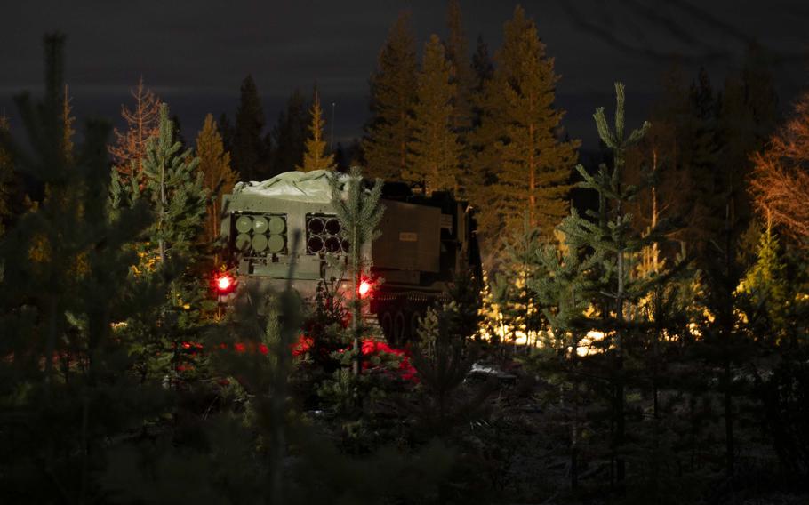 A Multiple Launch Rocket System is tested in a winter forest landscape.