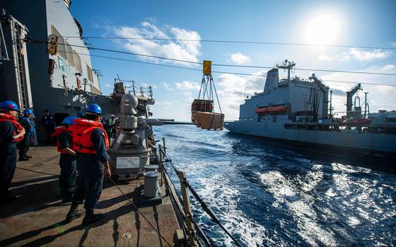 The destroyer USS Laboon receives supplies from the Military Sealift Command fleet replenishment oiler USNS John Lenthall in the Atlantic Ocean in July 2023. The Navy is facing a critical shortage of skilled civilian mariners needed to man its hospital, oiler and other support ships managed by Military Sealift Command. 