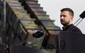 Ukraine's President Volodymyr Zelenskyy stands in front of a Patriot air defense missile system during a visit to a military training area in the German state of Western Pomerania, Tuesday, June 11, 20242, to learn about the training of Ukrainian soldiers on the "Patriot" air defence missile system. (Jens Buettner/dpa via AP)