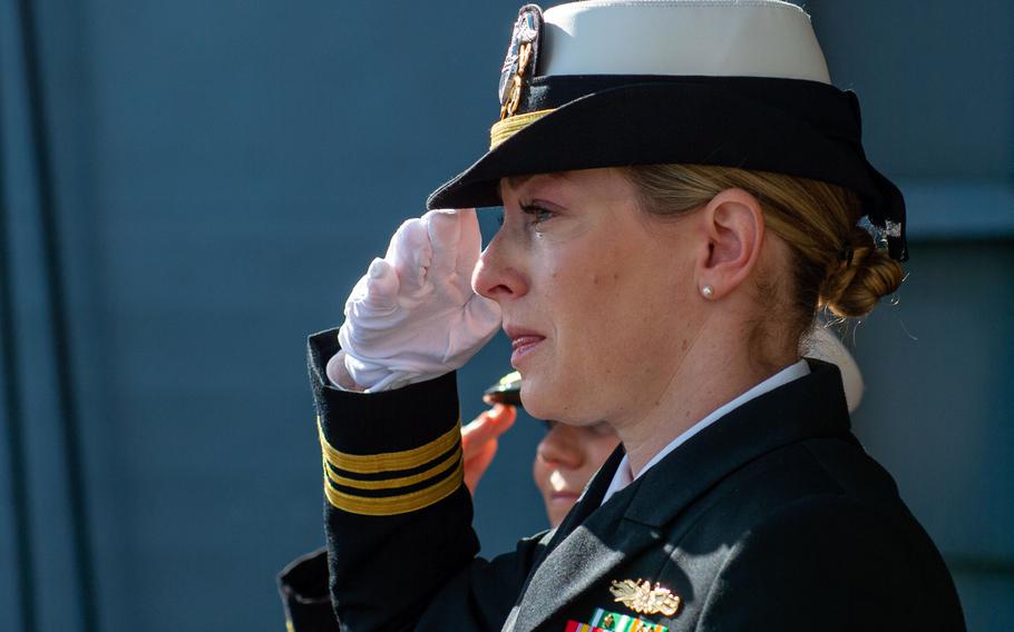 Lt. Cmdr. Alisen Rockwell, wife of former Navy junior officer Marc Rockwell-Pate, salutes during his burial at sea on Sept. 30, 2024, aboard the aircraft carrier USS Ronald Reagan while underway in the U.S. 3rd Fleet area of operations in the Pacific Ocean.