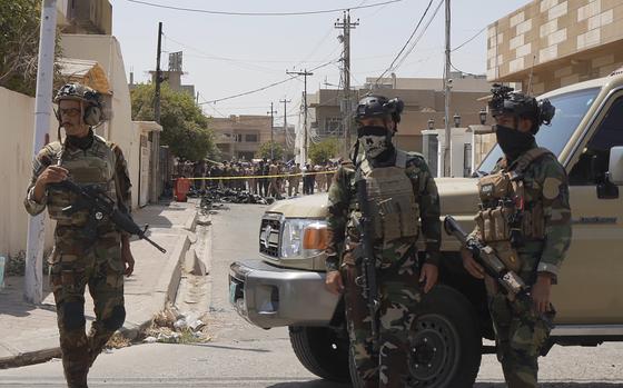 Iraqi Army soldiers stand guard near the debris of a drone shot down by Iraq's air defenses in Kirkuk, Iraq, Thursday, Aug. 29, 2024. (AP Photo/Str)