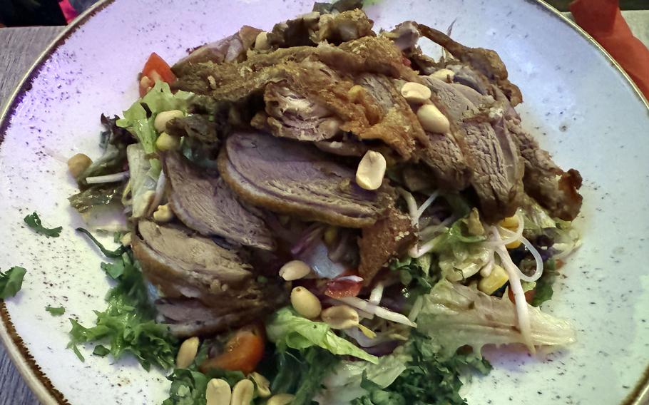 A salad topped with duck at a restaurant. in Frankfurt, Germany.