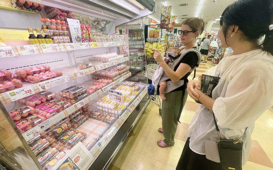 Akemi Kikugawa of the Japanese American Society helps Marine Corps spouse Camille Williamson shop at a Japanese grocery store near Marine Corps Air Station Iwakuni, Japan, Sept. 17, 2024.