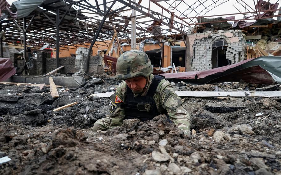 A Police bomb squad member works at the site of a Russian air strike, amid Russia’s attack on Ukraine, in Kharkiv, Ukraine, on Wednesday, May 22, 2024. 