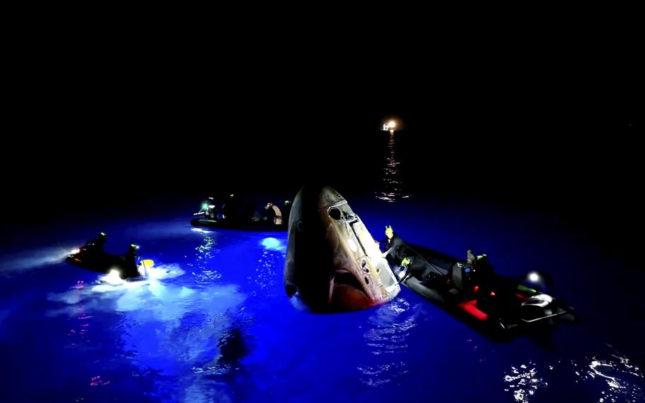 This image made from SpaceX video shows its capsule, center, carrying tech entrepreneur Jared Isaacman with his crew after it reached the Gulf of Mexico near Florida’s Dry Tortugas early Sunday, Sept. 15, 2024. 