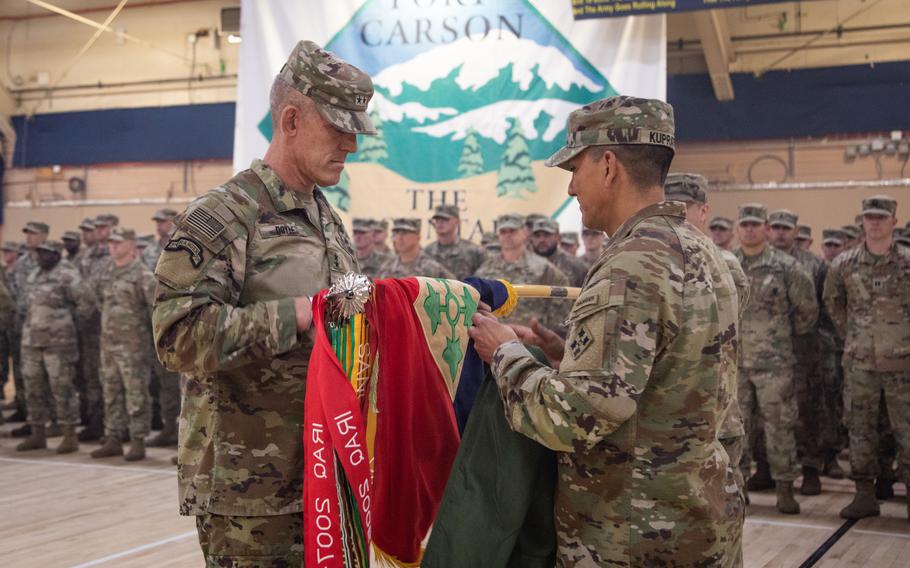 U.S. Army Maj. Gen. David Doyle, left, commander of the 4th Infantry Division, and Command Sgt. Maj. Alex Kupratty, right, command sergeant major of 4 ID, stand at attention during the division’s uncasing ceremony in the Special Events Center on Fort Carson, Colo., Sept. 13, 2023.