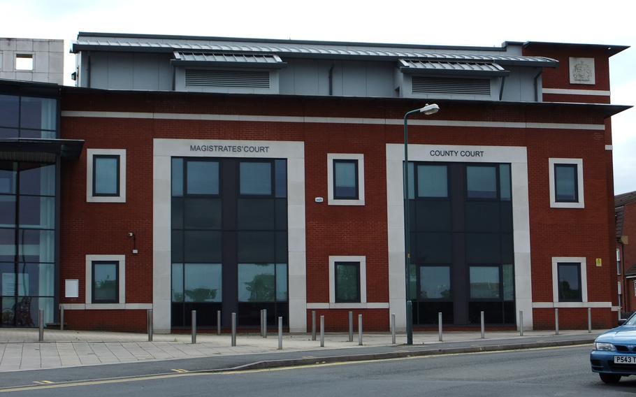 A modern building with two large glass fronts and red brick walls, representing the Kidderminster Magistrates Court in England. The structure has a contemporary design with clean lines, combining glass and brick elements. This is where U.S. soldier Isac Calderon pled guilty to causing serious injury by dangerous driving.