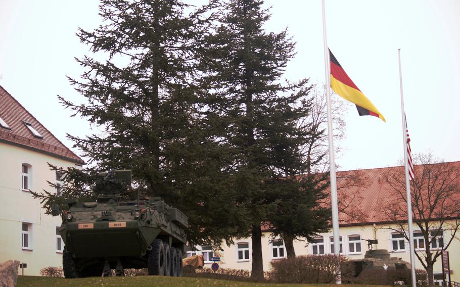 Armored vehicles are on display with the German and American flags.