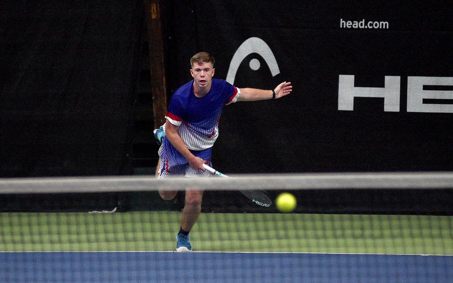 Ramstein's Tristan Chandler watches his serve as it crosses the net in a boys semifinal match against SHAPE's Alejandro Cuesta during the DODEA European tennis championships on Oct. 20, 2023, at T2 Sports Health Club in Wiesbaden, Germany.