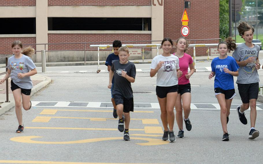 Coach Cornell Jones, far left, helms an Osan cross country team that's pretty much starting over.