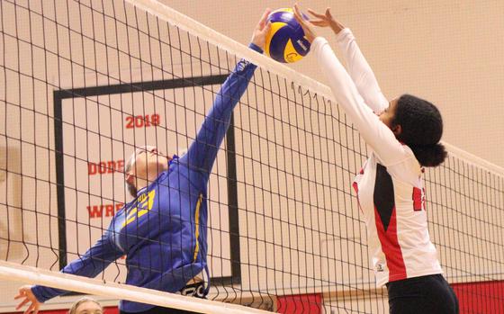 Yokota's Claire Smith and Nile C. Kinnick's Alyssa Staples battle at the net during Saturday's DODEA-Japan/Kanto Plain volleyball match. The Red Devils won in four sets.