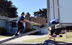 A mover loads a service member’s household goods into a truck in Pacific Grove, Calif., May 11, 2022.