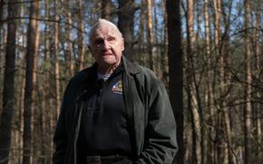 Lester Schrenk, who served as an Army B-17 ball turret gunner during World War II, stands in the forest outside Tychowo, Poland, on March 22, 2025, where he was detained as a prisoner of war 80 years earlier. 