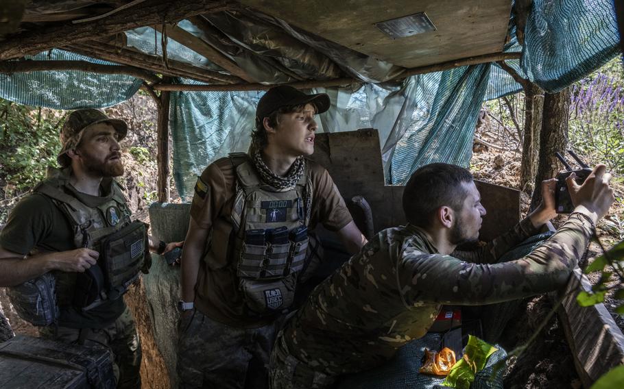 A Ukrainian soldier who goes by the call sign Labrador, left, and another soldier, center, watch as a colleague strives to control a surveillance drone in southeast Ukraine. Russian forces have for months been digging in to thwart Ukrainian attacks, Labrador said. 