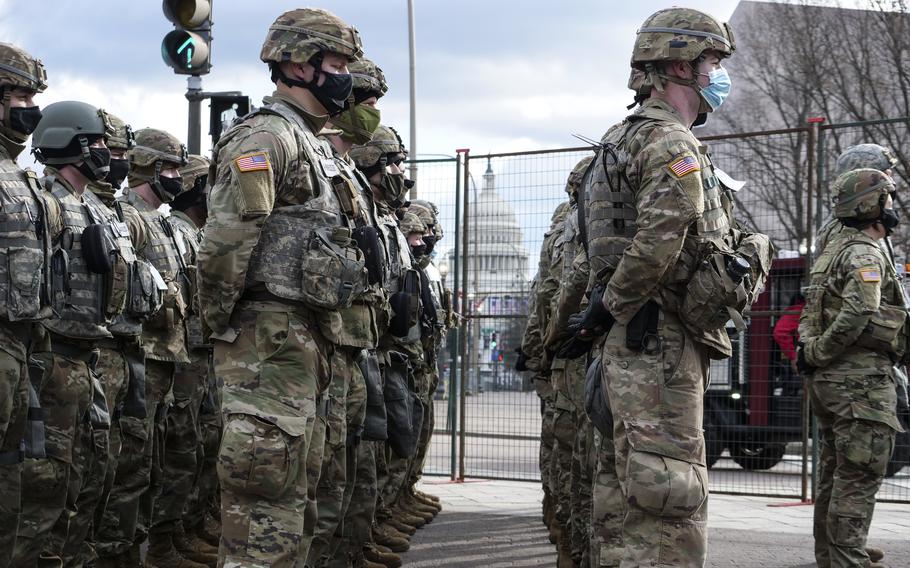 Troops stand in formation outside the White House.