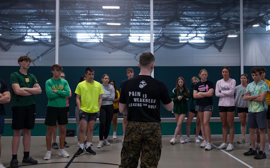 Marine Corps Sgt. Daniel Breuer, a recruiter for the service, leads high schoolers in strength and conditioning at Beckman-Dyersville Catholic High School in Dyersville, Iowa, on April 25, 2024. During the class, students participated in Marine Corps-style competitive workouts, learned about the importance of leadership, and were given the chance to ask questions about Marine Corps benefits and opportunities.