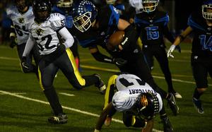 Ramstein running back Kydan Echard goes airborne after being tripped up by Stuttgart defender Sammy Johnson during the Division I DODEA European championship game on Nov. 1, 2024, at Ramstein High School on Ramstein Air Base, Germany.