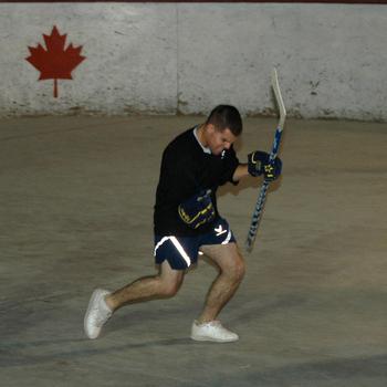 Airman 1st Class Ryan Dukett celebrates a goal with what he called his “Tiger Woods fist-pump” during a scrimmage of American players preparing for the upcoming season of the Kandahar Hockey League, a ball hockey organization based at Kandahar Air Field in southern Afghanistan.