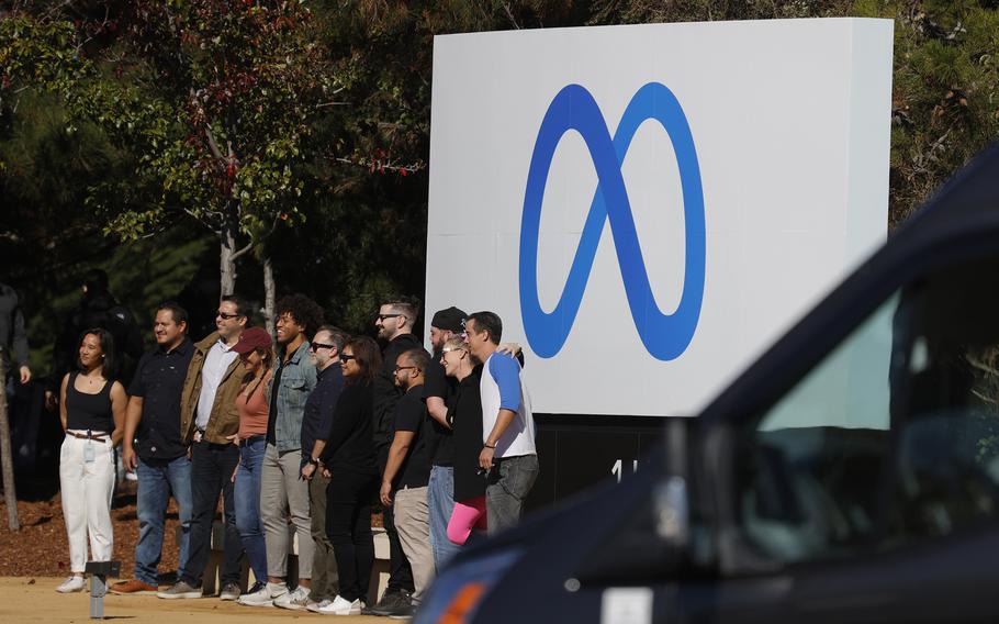 Facebook employees gather in front of a sign displaying a new logo and the name ‘Meta’ in front of Facebook headquarters in October 2021 in Menlo Park, Calif. As lawmakers and regulators in the U.S. consider policy born of their Big Tech concerns such as data privacy and artificial intelligence, they should carefully consider how such changes could end up trampling the small and midsize businesses that drive innovation and competition.